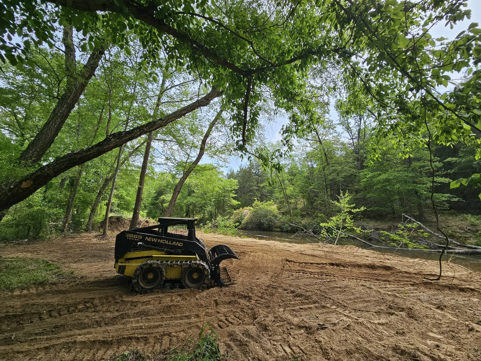 Skidsteer clearing waterfront property